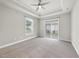 Expansive bedroom with tray ceiling, ceiling fan, plush carpet and access to backyard at 537 Bramble Ln, Clayton, NC 27527