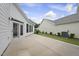 Concrete patio with glass doors and exterior lighting in a well-manicured backyard at 537 Bramble Ln, Clayton, NC 27527