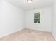 Cozy bedroom with plush carpet and natural light from one window, perfect for relaxation at 5429 Fortunes Ridge Dr, Durham, NC 27713