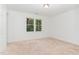 Bright bedroom featuring neutral carpeting and a large window at 5429 Fortunes Ridge Dr, Durham, NC 27713