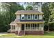 Charming two-story home featuring blue shutters and a cozy front porch, creating a welcoming curb appeal at 5429 Fortunes Ridge Dr, Durham, NC 27713