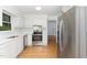 Modern kitchen with stainless steel appliances, white cabinets, and ample counter space, perfect for cooking at 5429 Fortunes Ridge Dr, Durham, NC 27713