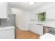 Modern kitchen with stainless steel appliances, white cabinets, and ample counter space, perfect for cooking at 5429 Fortunes Ridge Dr, Durham, NC 27713
