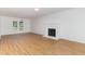 Bright living room showcasing hardwood floors and a decorative fireplace, offering a cozy and inviting atmosphere at 5429 Fortunes Ridge Dr, Durham, NC 27713