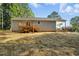 This house features a wooden deck and stairs leading to a large open backyard at 5500 Lake Wendell Rd, Zebulon, NC 27597