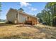 Backyard featuring a wooden deck and a well-maintained lawn at 5500 Lake Wendell Rd, Zebulon, NC 27597