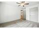 Inviting bedroom with carpet, ceiling fan, and access to another room with wood floors at 5500 Lake Wendell Rd, Zebulon, NC 27597