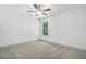 Bright bedroom with a ceiling fan, carpet, and a window with wooded views at 5500 Lake Wendell Rd, Zebulon, NC 27597