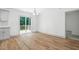 Bright dining area featuring wood floors, a sliding glass door to the deck, and modern lighting at 5500 Lake Wendell Rd, Zebulon, NC 27597