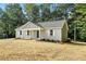 View of the side and front of a single-story home with light gray siding at 5500 Lake Wendell Rd, Zebulon, NC 27597