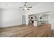 Open floor plan with modern hardwood floors connecting living room and kitchen at 5500 Lake Wendell Rd, Zebulon, NC 27597