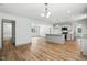 Open-concept living space boasts wood flooring, modern lighting, and seamless flow between rooms at 5500 Lake Wendell Rd, Zebulon, NC 27597
