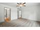 This main bedroom features neutral gray walls and carpeting, with an open ensuite bathroom at 5500 Lake Wendell Rd, Zebulon, NC 27597