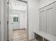 Well-lit mud room features wood flooring, built-in bench, coat hooks, and access to the exterior at 5500 Lake Wendell Rd, Zebulon, NC 27597