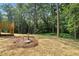 A beautiful yard with lush trees and manicured landscaping surrounds the home at 5500 Lake Wendell Rd, Zebulon, NC 27597