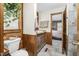 Cozy bathroom with a sink, and a toilet adjacent to a window at 5593 Leon Rd, Nashville, NC 27856