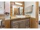 Modern bathroom vanity with wood accents, stylish mirror, and contemporary fixtures at 5593 Leon Rd, Nashville, NC 27856
