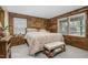 Bedroom featuring a bed, carpet, and natural wood plank walls at 5593 Leon Rd, Nashville, NC 27856