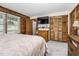 Comfortable bedroom featuring warm wood paneling and plenty of closet space at 5593 Leon Rd, Nashville, NC 27856