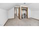 Neutral bedroom with carpeted floors leads to additional rooms and a closet at 5593 Leon Rd, Nashville, NC 27856
