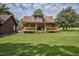 Charming log cabin with a spacious wooden deck and well-maintained lawn at 5593 Leon Rd, Nashville, NC 27856