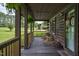 Cozy front porch with rocking chairs and charming details, perfect for relaxing outdoors at 5593 Leon Rd, Nashville, NC 27856