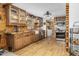 Well-lit kitchen featuring wood floors, cabinets, stainless steel appliances and farmhouse sink at 5593 Leon Rd, Nashville, NC 27856