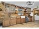 Well-appointed kitchen with custom wood cabinets, farmhouse sink, and modern stainless steel appliances at 5593 Leon Rd, Nashville, NC 27856