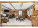 Inviting living room with a fireplace, beamed ceilings, and natural wood accents at 5593 Leon Rd, Nashville, NC 27856