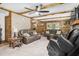 Comfortable living room with a fireplace, wood-paneled walls, and cozy furnishings at 5593 Leon Rd, Nashville, NC 27856