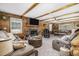 Spacious living room with wood paneled walls, beamed ceilings, and cozy fireplace at 5593 Leon Rd, Nashville, NC 27856