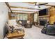 Living room featuring a brick fireplace, wood paneling, beamed ceiling and comfortable seating at 5593 Leon Rd, Nashville, NC 27856