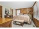 Bedroom features wood paneled walls, neutral carpet, and a decorative wood nightstand for a modern cabin aesthetic at 5593 Leon Rd, Nashville, NC 27856