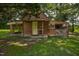 Rustic log cabin outbuilding with covered area and garden space at 5593 Leon Rd, Nashville, NC 27856