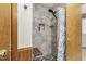 Updated shower with pebble flooring, tiled walls, and a built-in bench at 5593 Leon Rd, Nashville, NC 27856