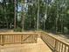 A wooden deck surrounded by nature offers a peaceful outdoor space for relaxing or entertaining at 57 Blanton Ct, Lillington, NC 27546
