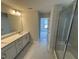 Bright bathroom featuring double vanity, white marble floors and large glass enclosed shower at 57 Blanton Ct, Lillington, NC 27546