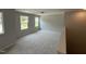 Carpeted bonus room featuring two windows at 57 Blanton Ct, Lillington, NC 27546