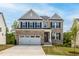 Beautiful two-story brick home with attached two car garage and a well-manicured lawn on a sunny day at 57 Blanton Ct, Lillington, NC 27546