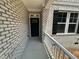 A welcoming front entryway showcasing the detailed brickwork and black door at 57 Blanton Ct, Lillington, NC 27546