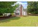 Large backyard showcasing a pool, a deck, a screened porch, and a well-manicured lawn at 5833 Dahlberg Dr, Raleigh, NC 27603