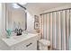 Stylish bathroom featuring a modern vanity, framed artwork, and a patterned shower curtain at 5833 Dahlberg Dr, Raleigh, NC 27603
