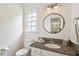 Well-lit bathroom featuring granite counters, a modern mirror and fresh design at 5833 Dahlberg Dr, Raleigh, NC 27603