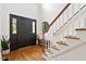 Bright foyer with hardwood floors, a staircase, and stylish decor creating a welcoming entrance at 5833 Dahlberg Dr, Raleigh, NC 27603
