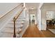 Bright foyer showcasing hardwood floors, staircase, and views into the dining room at 5833 Dahlberg Dr, Raleigh, NC 27603