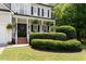 Inviting front porch with manicured greenery, hanging plants, and classic black shutters at 5833 Dahlberg Dr, Raleigh, NC 27603