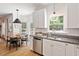 Bright eat-in kitchen featuring granite counters, stainless appliances, and modern lighting at 5833 Dahlberg Dr, Raleigh, NC 27603