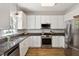 Bright kitchen with stainless steel appliances, granite countertops, and pendant lighting at 5833 Dahlberg Dr, Raleigh, NC 27603