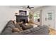 Cozy living room features a comfortable sectional sofa, fireplace, and backyard access at 5833 Dahlberg Dr, Raleigh, NC 27603