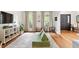 Playroom area featuring a modern sofa, hardwood floors, and natural light from large windows at 5833 Dahlberg Dr, Raleigh, NC 27603